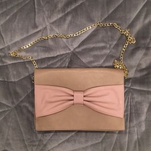 Large beige clutch with pink bow from Ambiance